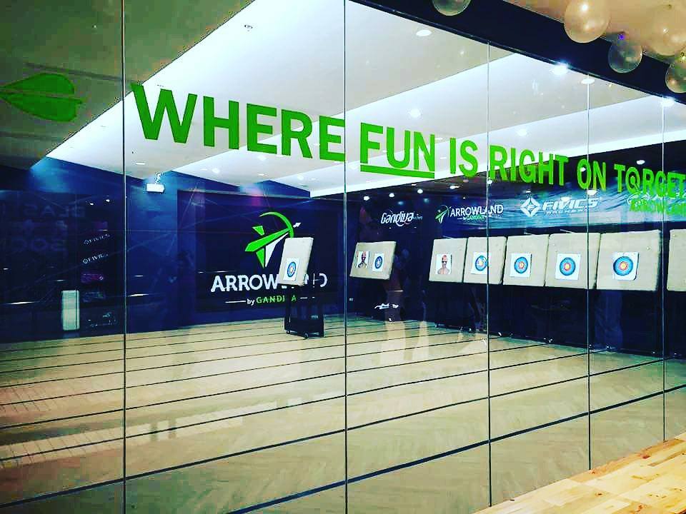 Arrowland range with foam targets and brand banners on the back wall