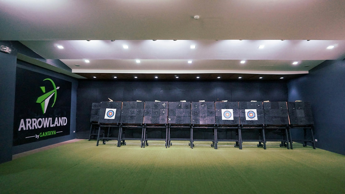 Arrowland targets with arrows embedded showing range layout from shooting line